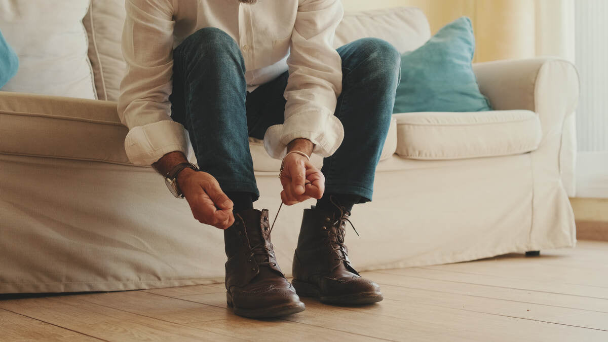 man tying boots