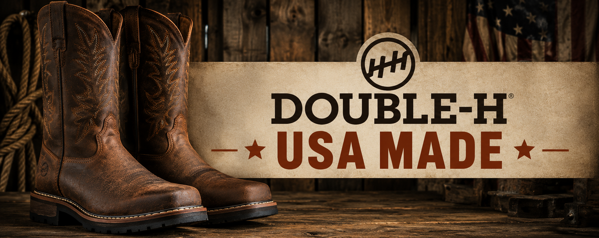 A pair of brown western cowboy boots displayed against a rustic wooden backdrop with a large banner reading 'DOUBLE-H USA MADE' and a Double-H logo.
