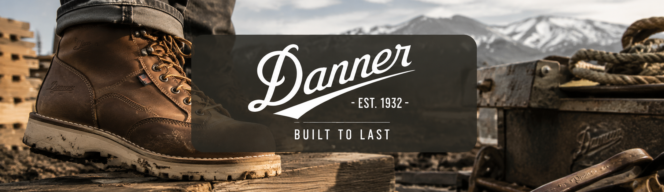A close-up of a brown leather work boot with a rugged sole, shown in a rustic outdoor setting with mountains in the background. A dark semi-transparent banner across the center displays the brand name 'Danner' with the tagline 'BUILT TO LAST'.
