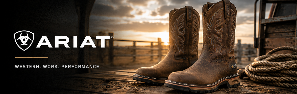 A pair of Ariat western work boots in brown leather, displayed on a wooden dock with a sunset background and the Ariat logo on the left.