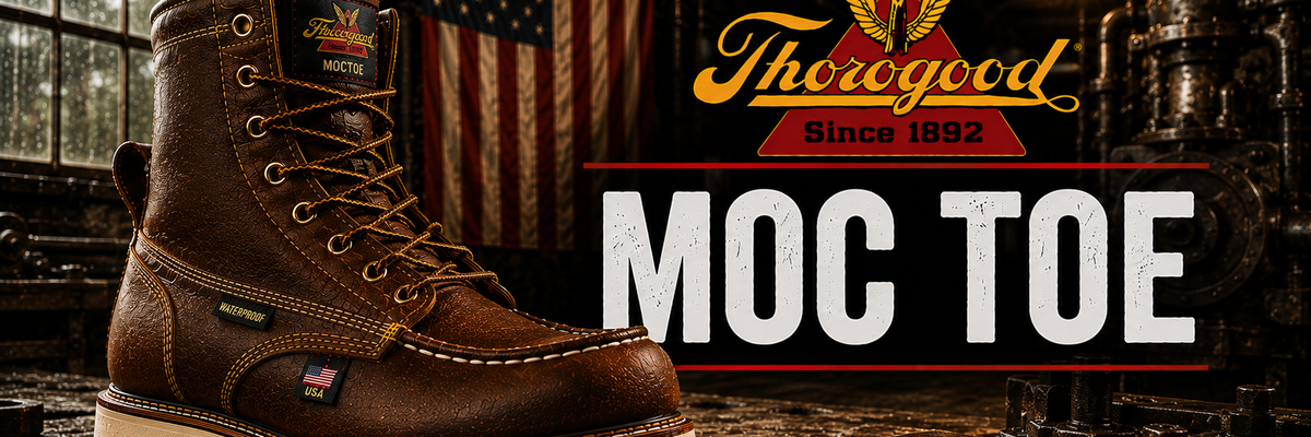 A brown leather Thoroughbred MOC Toe work boot with a thick off-white sole, shown in a dark industrial workshop setting with an American flag in the background. The Thoroughbred logo and 'MOC TOE' text are displayed on the right.