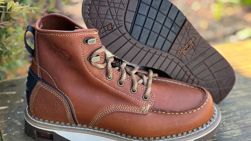 Georgia men’s Amped lightweight wedge work boot in brown leather with Goodyear welt and slip-resistant outsole, displayed outdoors.