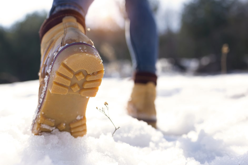 Woman wearing non-slip shoes on the snow.