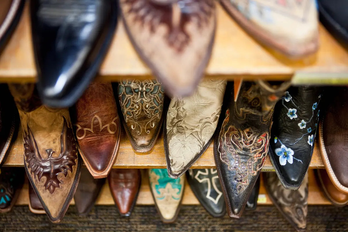 collection of cowboy work boots on the shelf