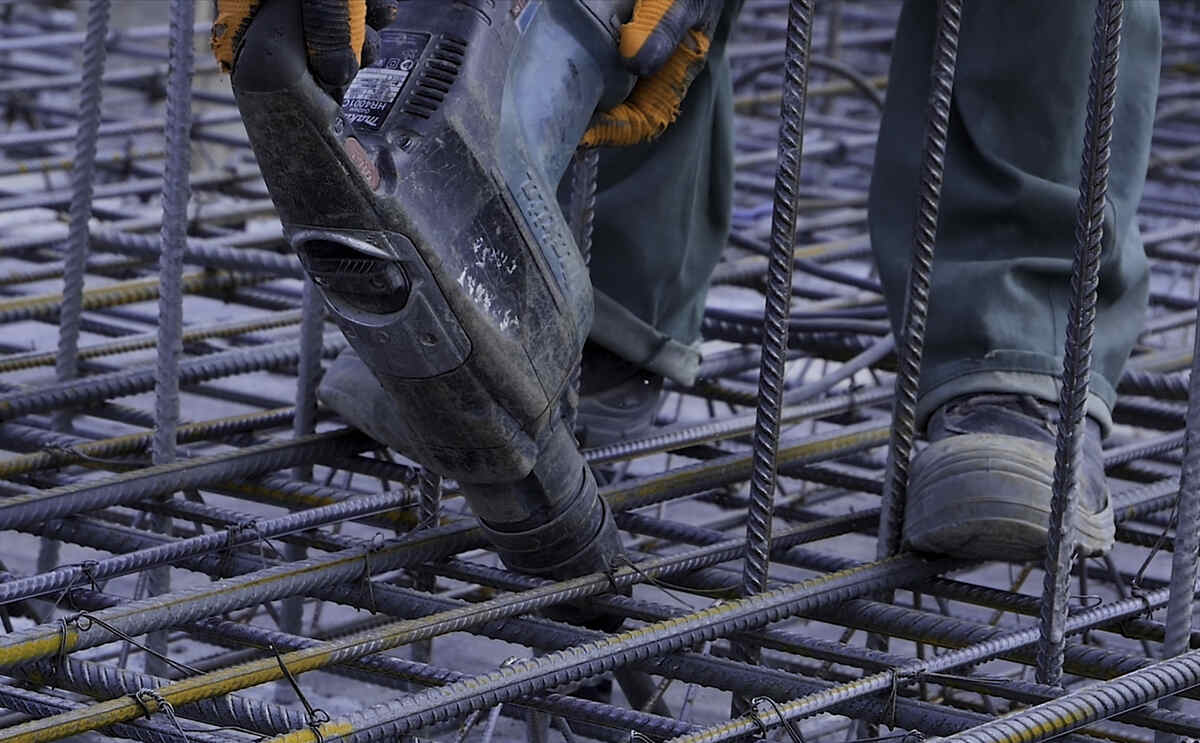 worker in safety boots works on construction site