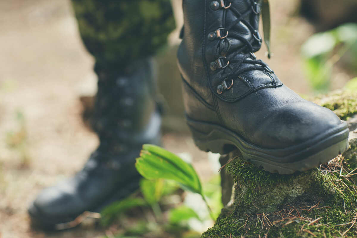 soldiers legs with black tactical boots