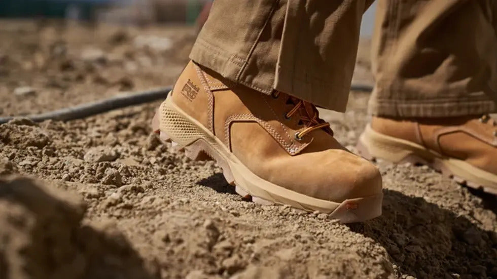 Timberland PRO work boots on rough jobsite ground for durable outdoor work.