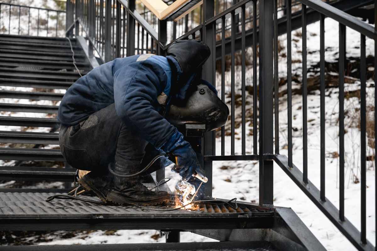 welder works outside in his work boots