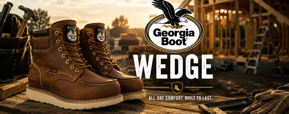 A pair of brown leather wedge work boots displayed on a wooden surface in a construction site setting at sunset, with the Georgia Boot logo and the word WEDGE prominently overlaid.