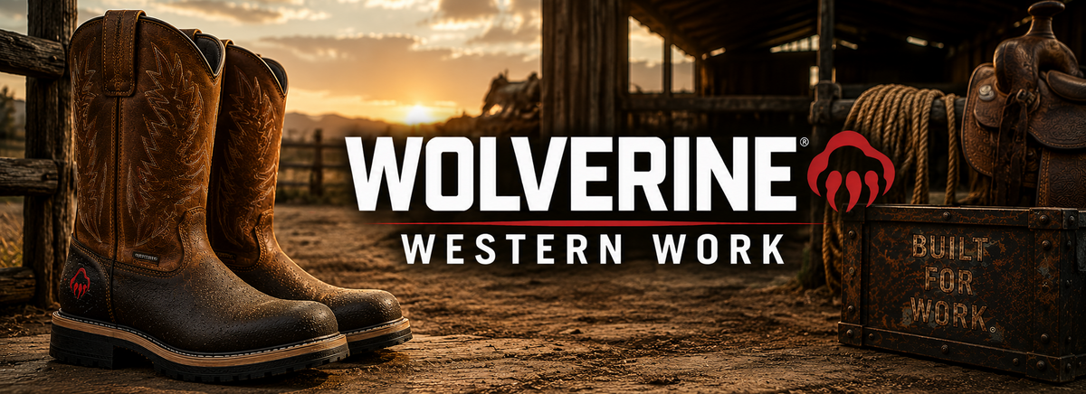 A pair of brown leather cowboy boots standing on a dirt ground next to a wooden fence, with a western barn and sunset in the background. Large text overlay reads 'WOLVERINE WESTERN WORK' with a red wolf head logo, and 'BUILT FOR WORK' is visible on a wooden crate.