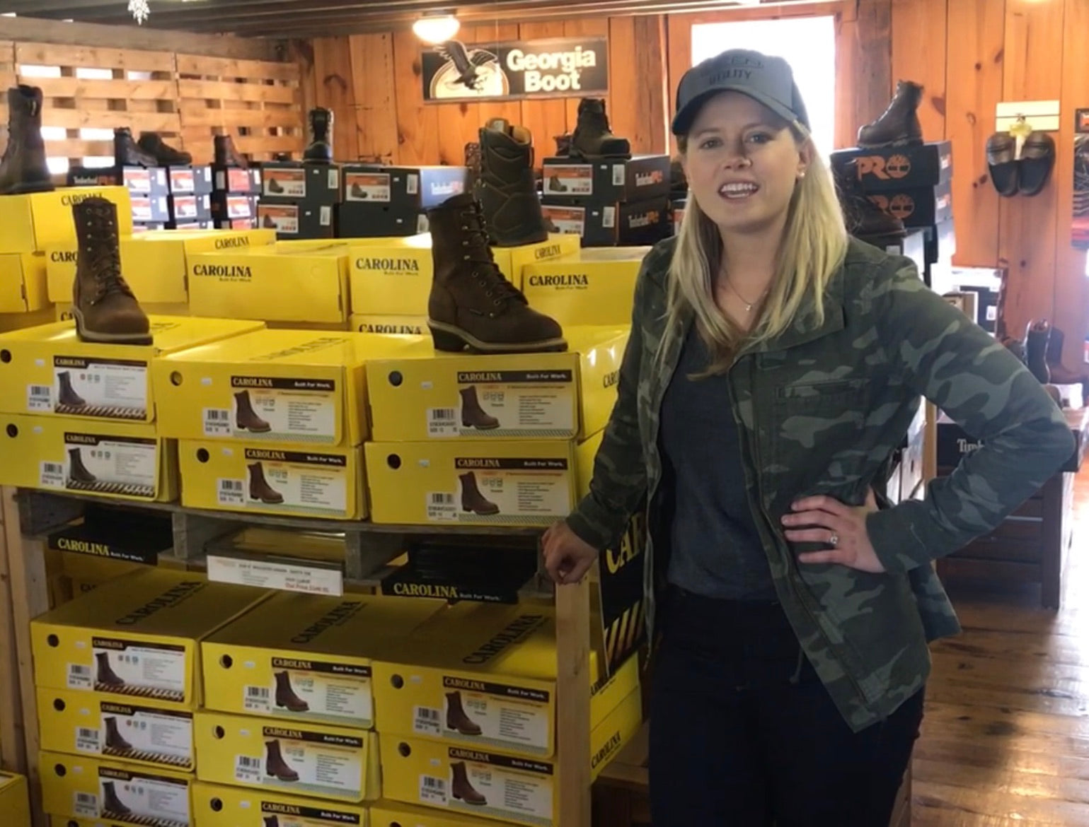 A woman standing in Overlook Boots shop