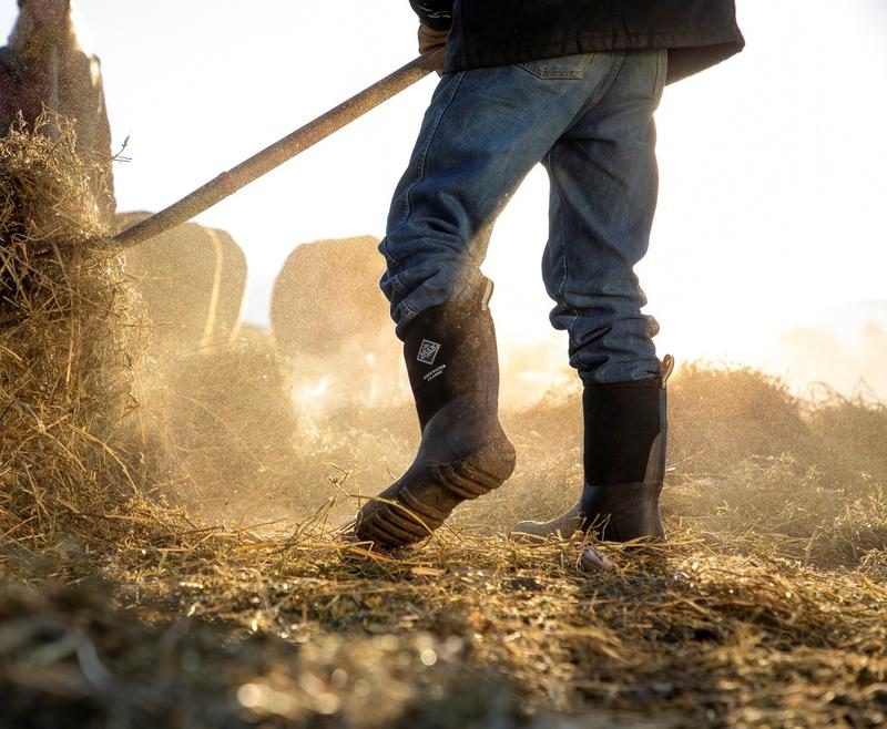  A man in boots works in the field